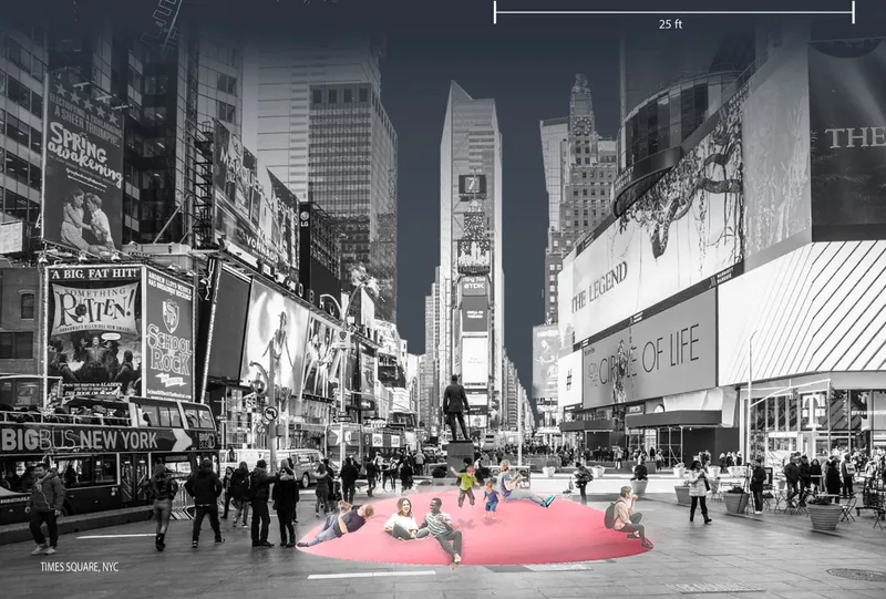 Pink inflatable seating installation in an urban plaza surrounded by pedestrians and illuminated signage at dusk
