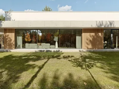 PL.Architekci Frames a Poznań Family Home in Concrete and Timber Against a Pine Forest