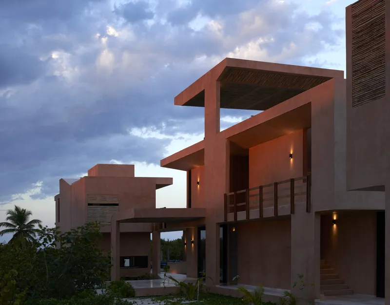 Stepped concrete terraces with slatted timber ceilings and railings under dramatic cloudy sky at sunset