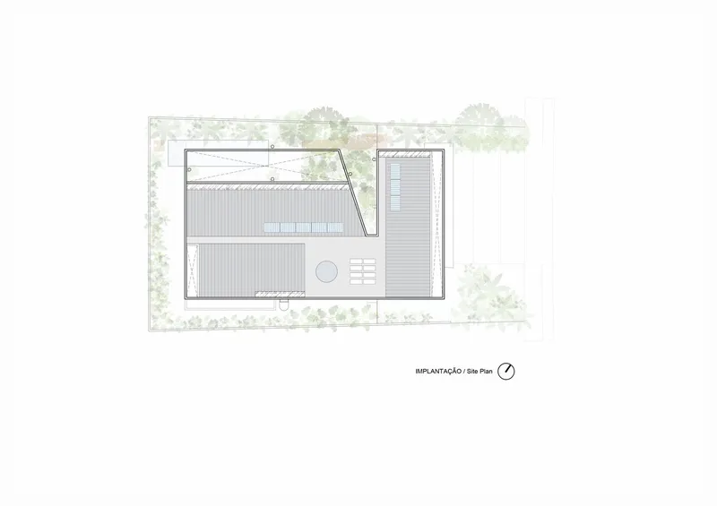 Site plan drawing showing rectangular building footprint with pool and surrounding vegetation