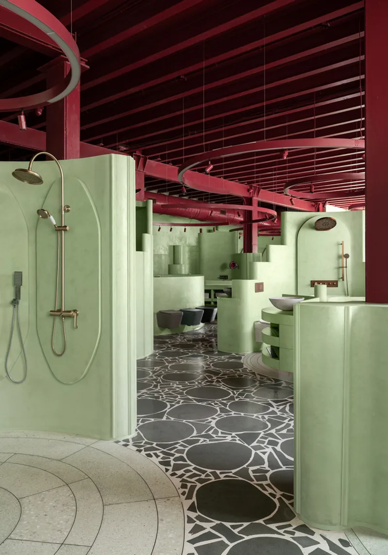 Interior view showing green shower enclosures and patterned floor beneath exposed red ceiling beams
