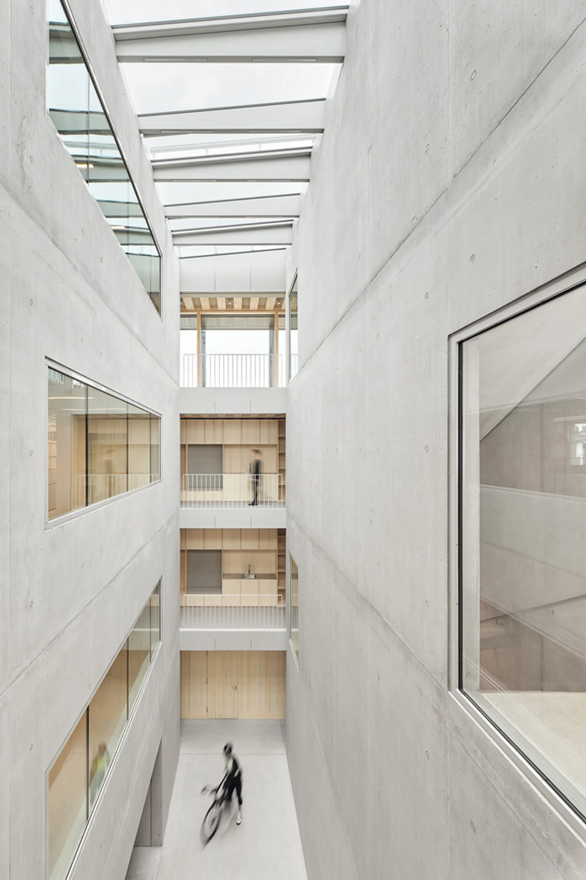 VON M Architects Wrap a Tübingen Office Building in Weathered Timber and Raw Concrete
