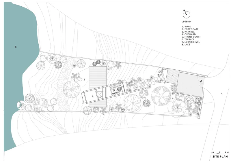 Site plan drawing showing building volumes oriented along a sloping site between a lake and road