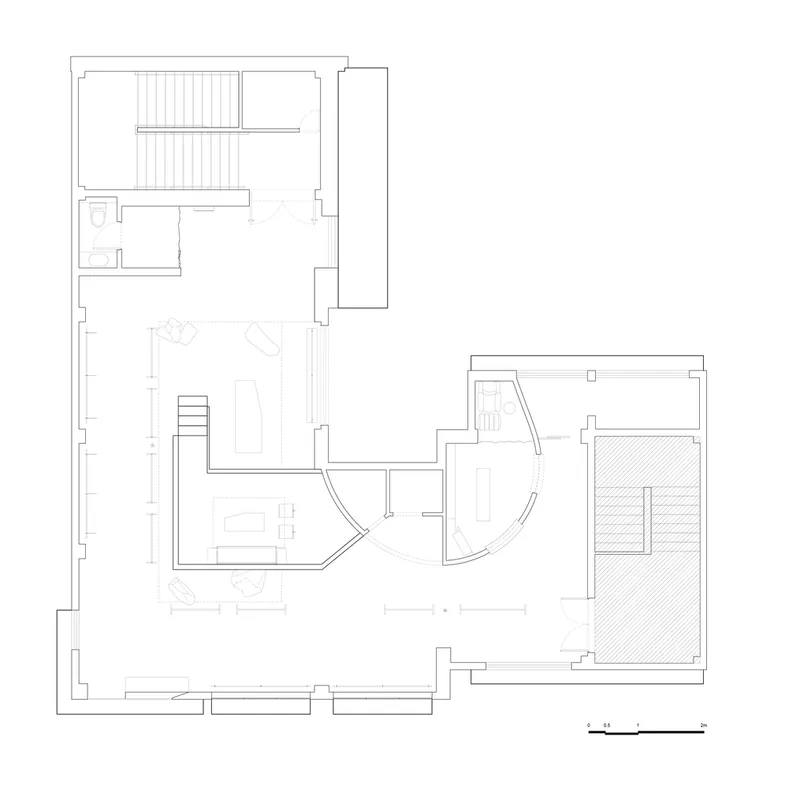 Floor plan drawing showing rooms organized around curved walls and a central staircase