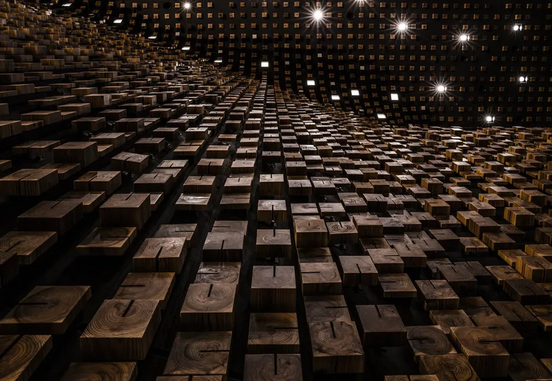 Close-up of recessed timber block acoustic wall showing varied depths and recessed lighting fixtures
