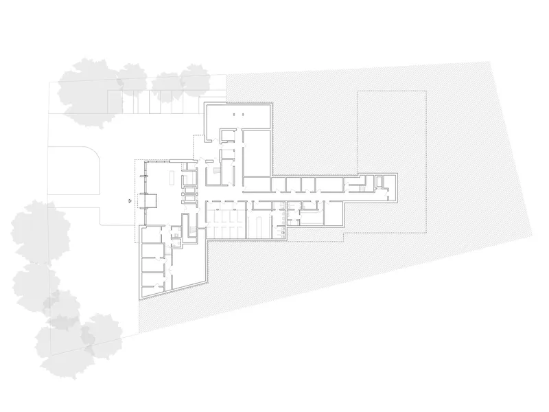Ground floor plan drawing showing rooms and corridors with textured paving areas and tree canopies