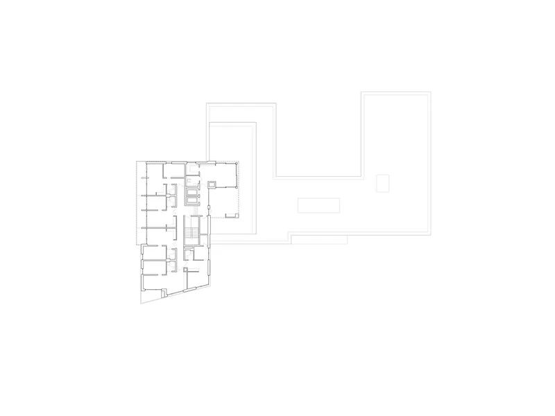 Floor plan drawing showing one residential wing adjacent to two large rectangular volumes