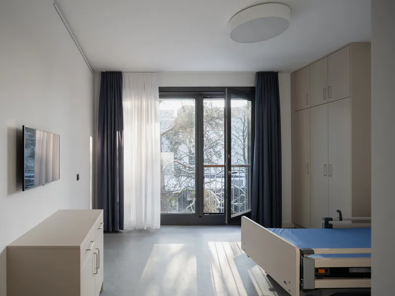 Residential room with built-in cabinetry and glass doors opening to a winter balcony