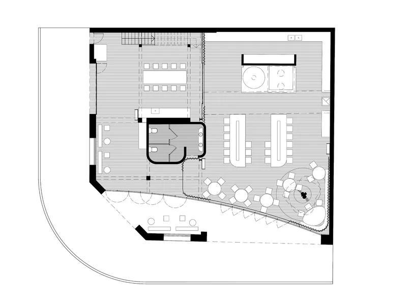 Floor plan drawing showing dining areas, restrooms, and angled outdoor terrace with circular seating
