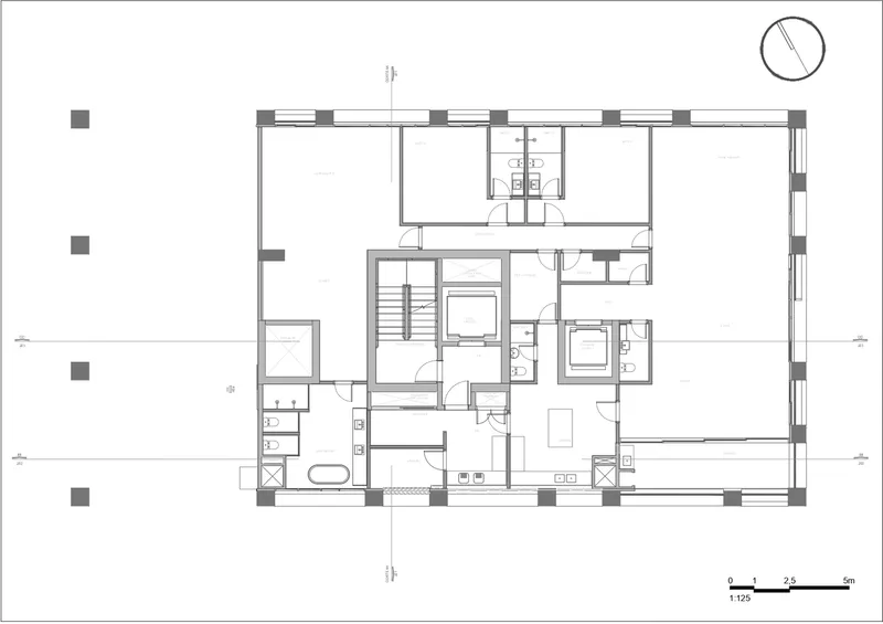 Floor plan drawing depicting residential units with central staircase and bathroom cores