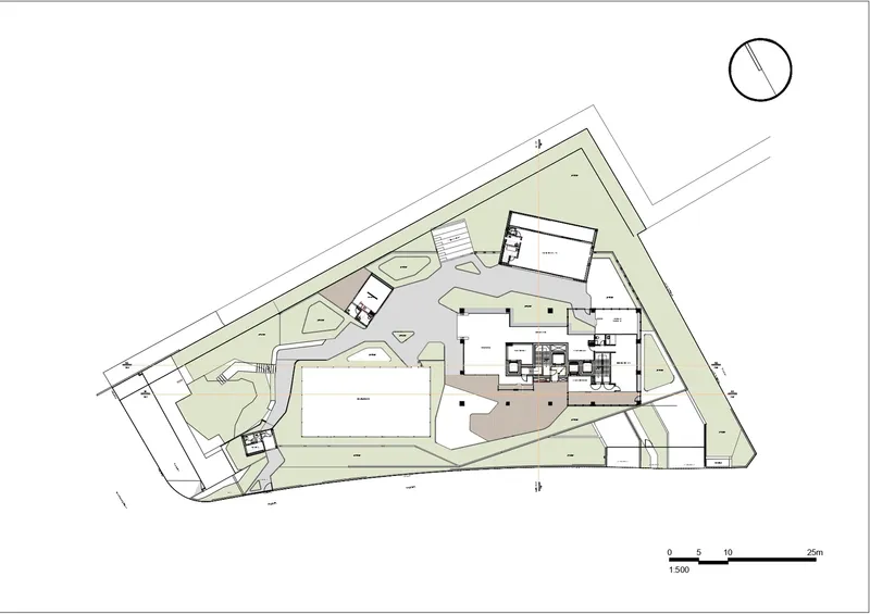 Site plan drawing showing multiple buildings within a triangular parcel with landscaped areas