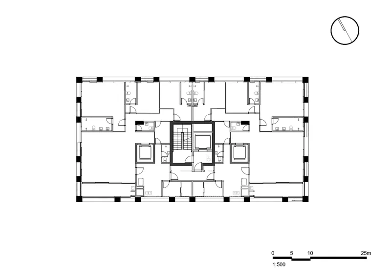 Floor plan drawing depicting symmetrical residential units arranged around a central circulation core