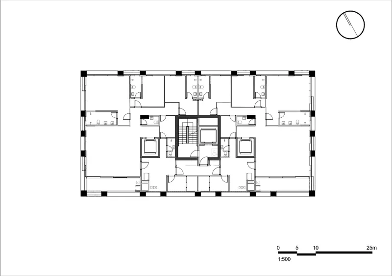 Floor plan drawing showing symmetrical residential units arranged around a central stair and elevator core