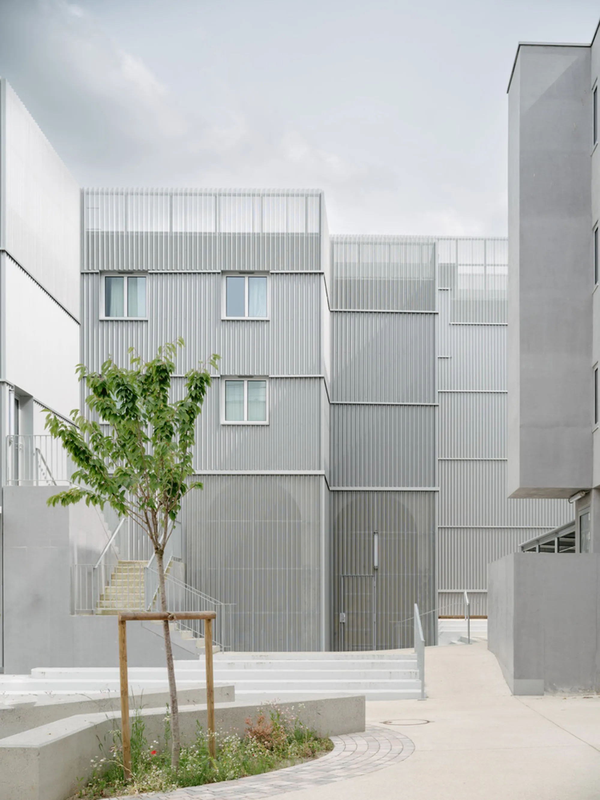 graal Architecture Wraps a 1965 Student Residence in Folded Steel Instead of Demolishing It