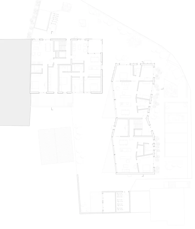 Floor plan drawing showing rectangular volume connected to curved wing with multiple residential units