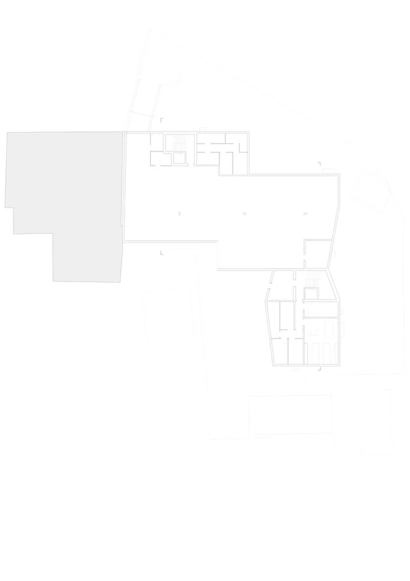 Site plan drawing showing angled building footprint with adjacent volumes and room divisions