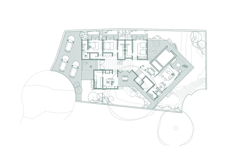 Floor plan drawing showing two angled volumes connected by corridors with circular tree canopies