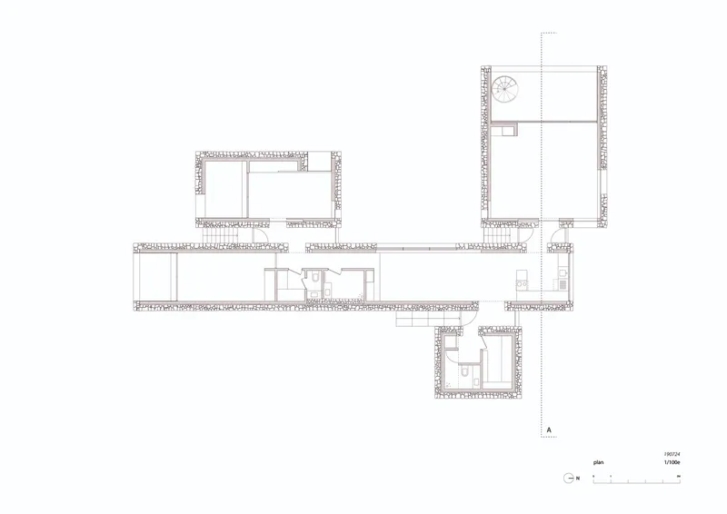 Floor plan drawing showing four pavilions connected by a linear corridor on sloping terrain