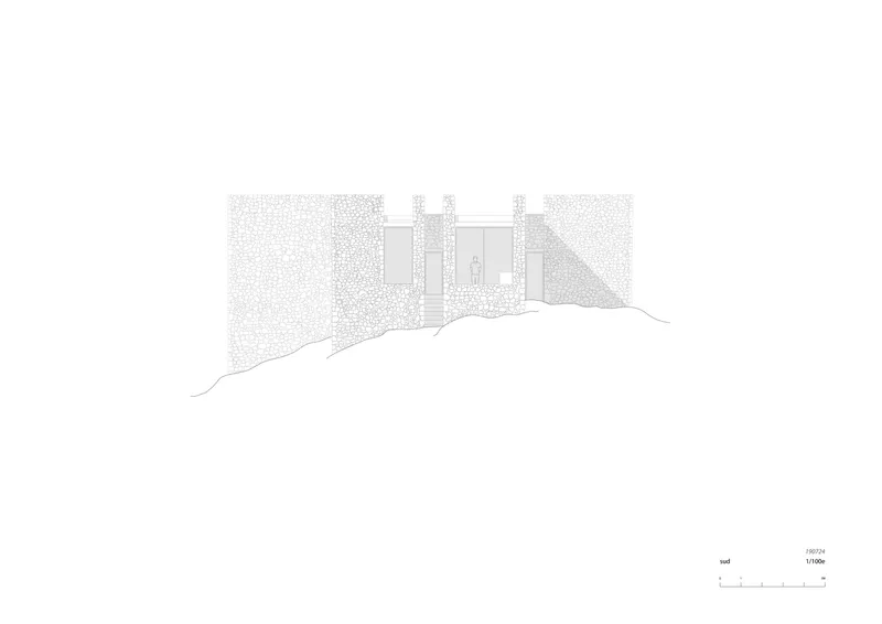 Elevation drawing showing a textured stone wall with recessed openings set into sloping terrain