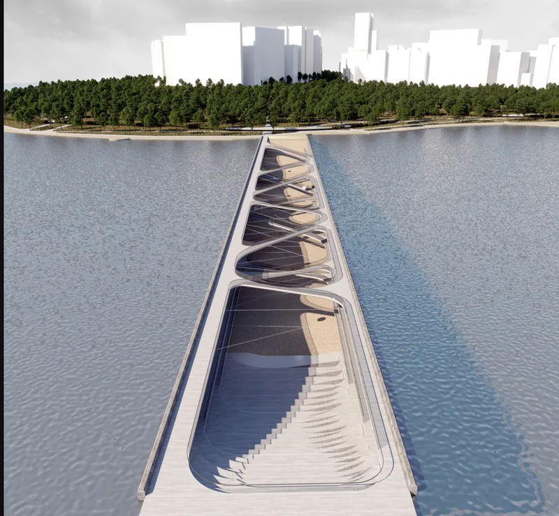 Aerial view of the triangular pedestrian bridge with ribbed underbelly spanning the calm water to forested shore