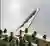 The image presents an architectural rendering of a modern pier extending into a body of water. The p