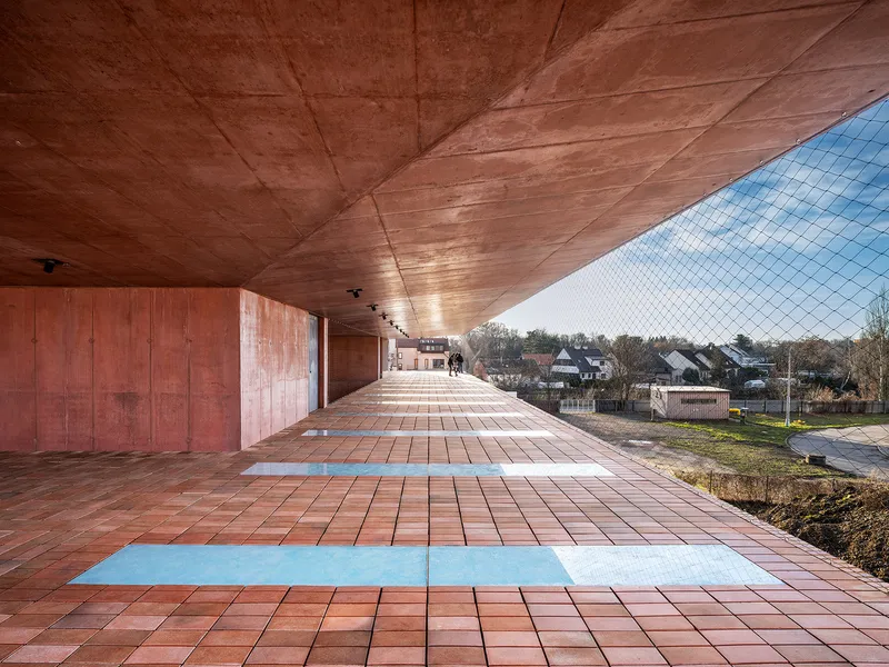Covered terrace with red tile floor and sloped concrete soffit overlooking suburban rooftops