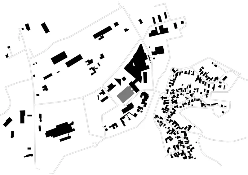 Site plan drawing showing scattered building volumes within a residential neighborhood and curved road patterns