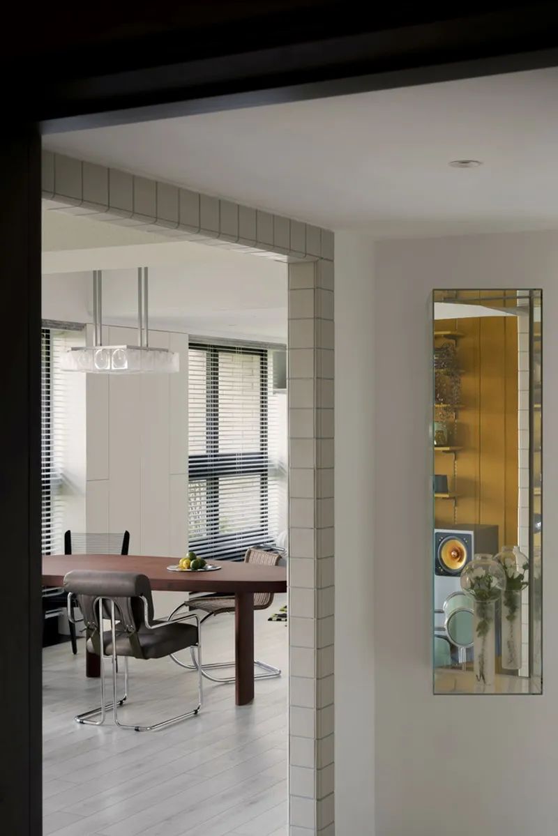 View through tiled doorway into dining area with venetian blinds filtering daylight