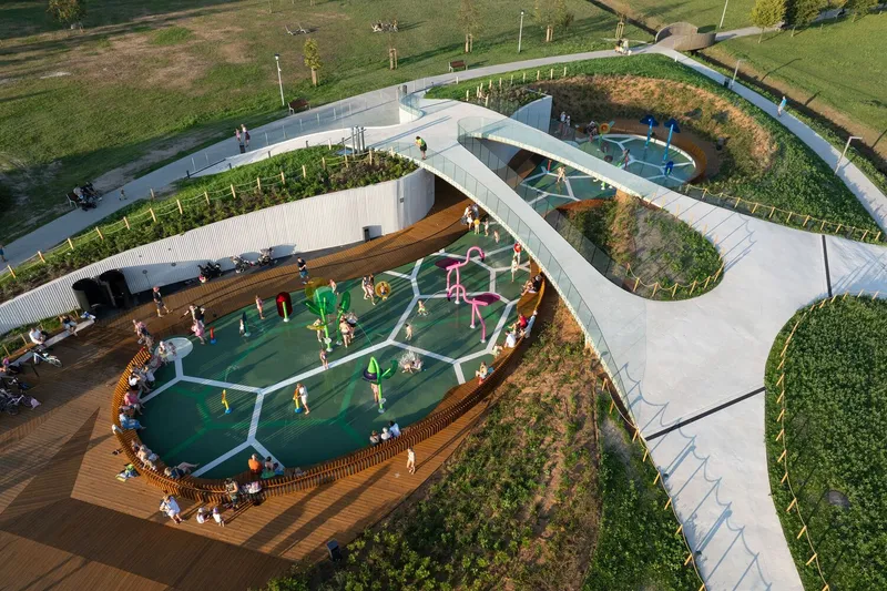 Overhead view of the hexagonal green play surface surrounded by timber decking and climbing structures