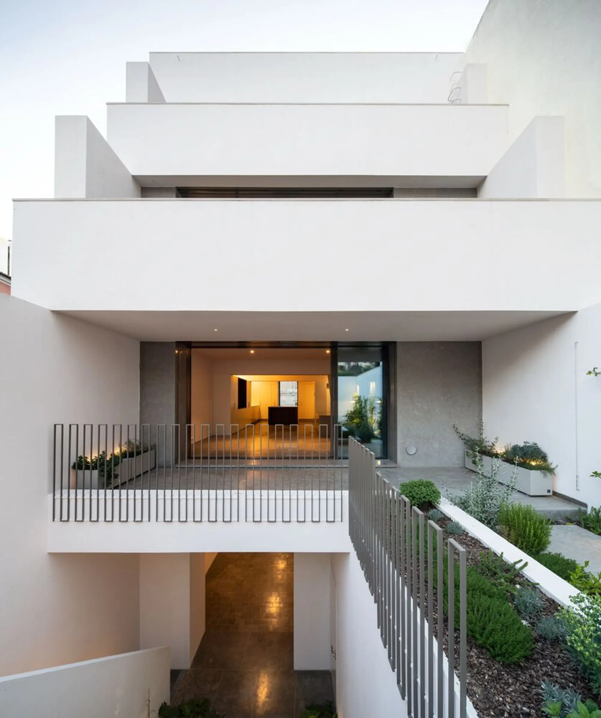 Camarim Arquitectos Unfolds a Lisbon Townhouse into Layered Stone, Walnut, and Marble