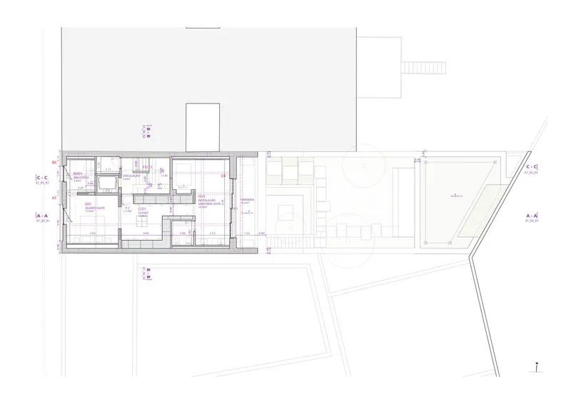 Floor plan drawing showing a narrow residence with rooms along one side and an angled courtyard