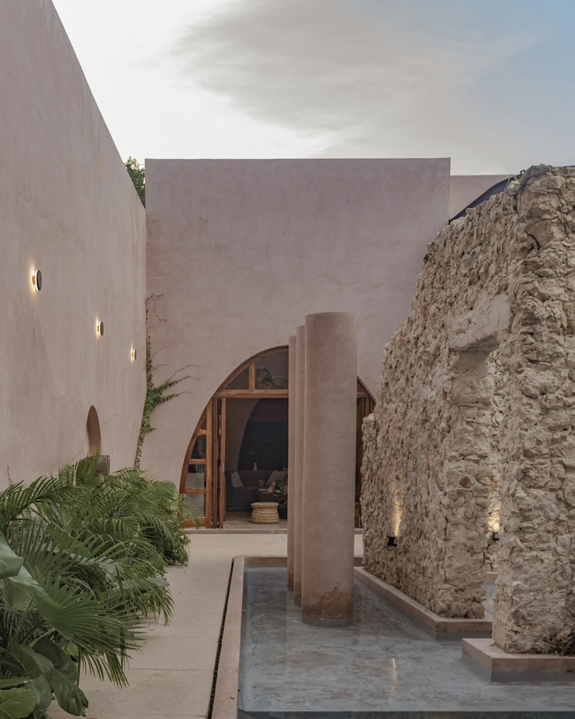 Enekén Studio Wraps an Ancient Stone Ruin in Pink Walls and Poolwater in Mérida