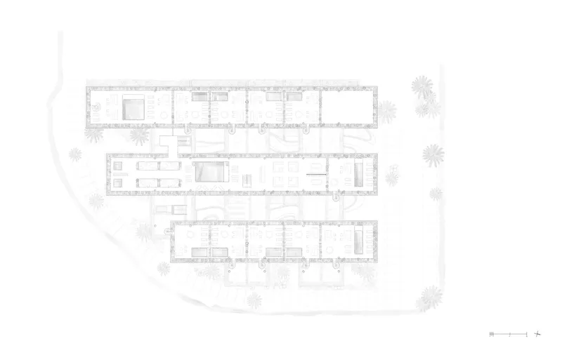 Floor plan drawing showing three linear residential bars arranged around a curved site with surrounding trees