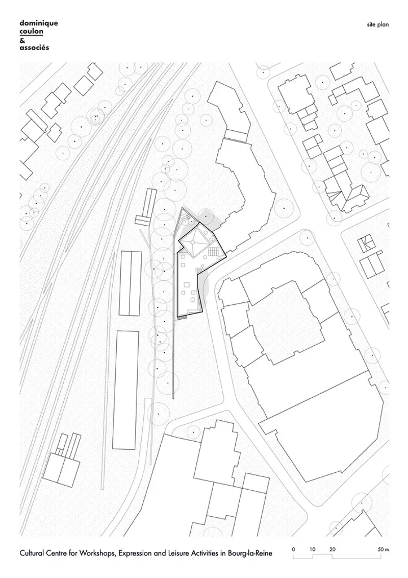 Site plan drawing showing the angular building footprint nestled between railway lines and adjacent structures