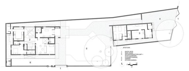 Site plan drawing showing two built volumes separated by a landscaped courtyard with circular tree canopies
