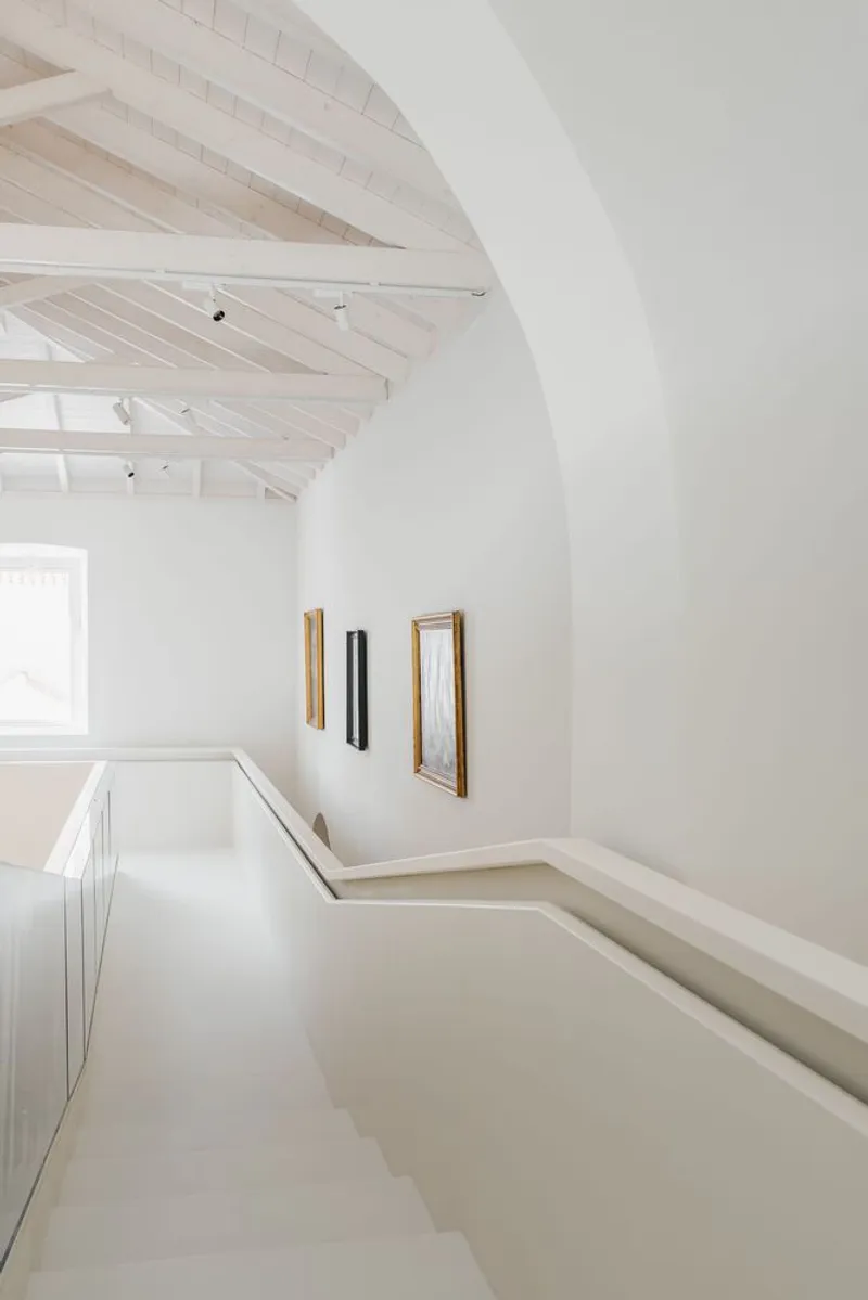 Corner of the mezzanine level showing the arched opening and light timber roof structure above