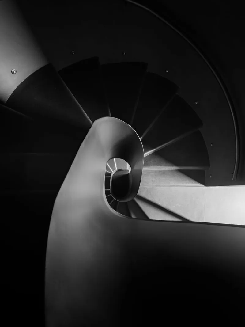 Overhead view of the spiral staircase descending in diminishing curves