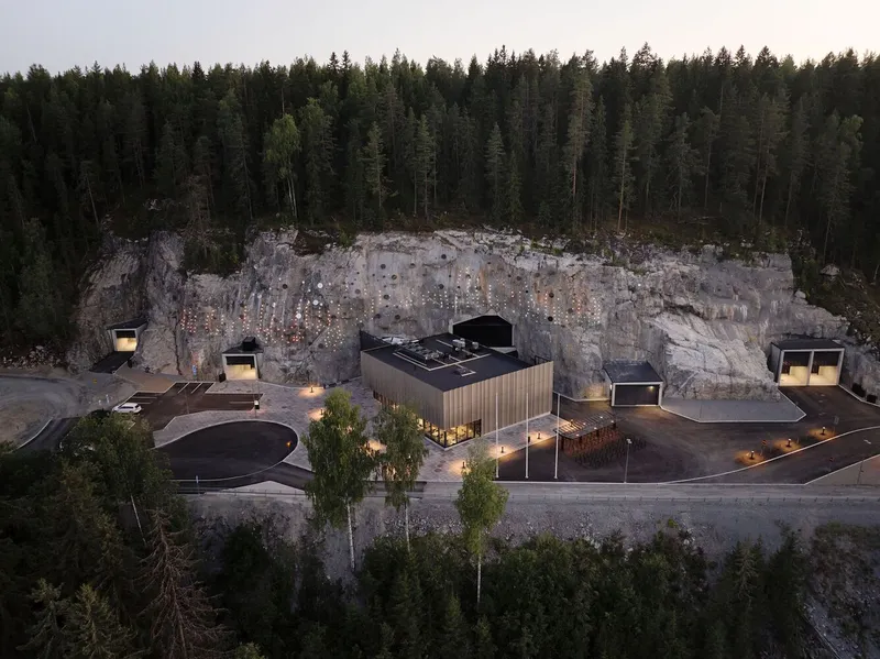 Aerial view of the complex set into a former quarry cliff face at dusk