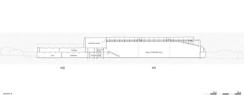 Section drawing revealing a multi-purpose hall with exposed roof trusses adjacent to storage and corridor spaces