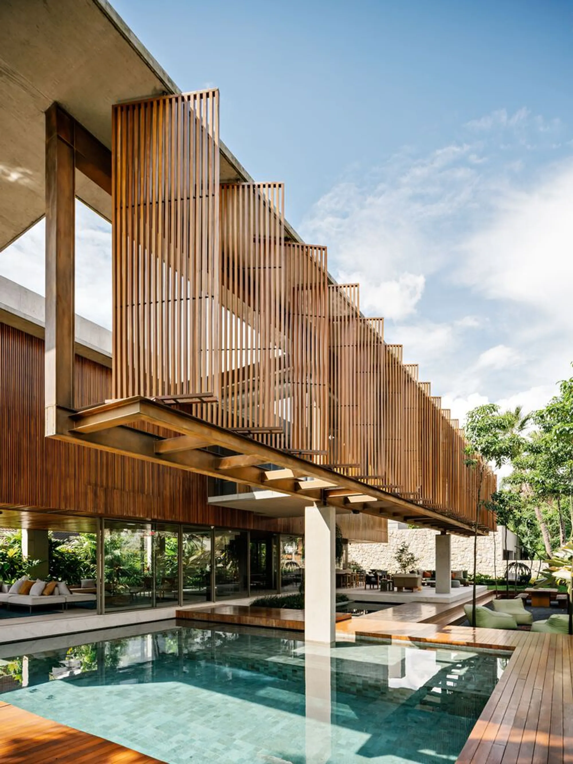 FGMF Suspends a Cumaru Wood Volume Over a Glass Pavilion in São Paulo's Tropical Suburbs