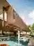 FGMF Suspends a Cumaru Wood Volume Over a Glass Pavilion in São Paulo's Tropical Suburbs