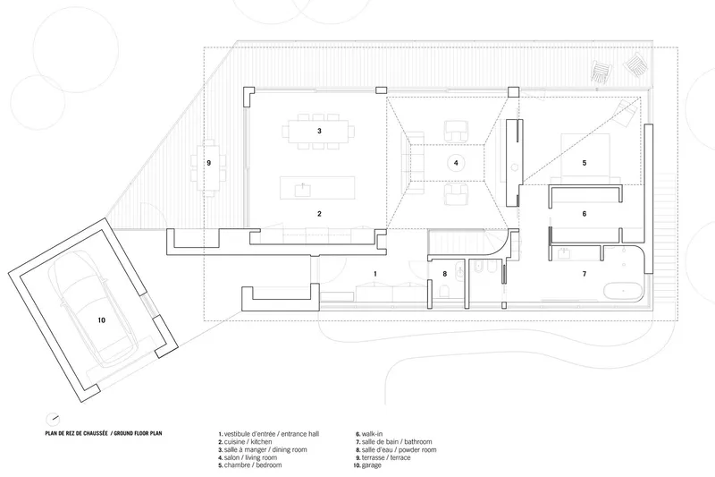 Ground floor plan drawing showing living and dining spaces with covered terrace and detached garage