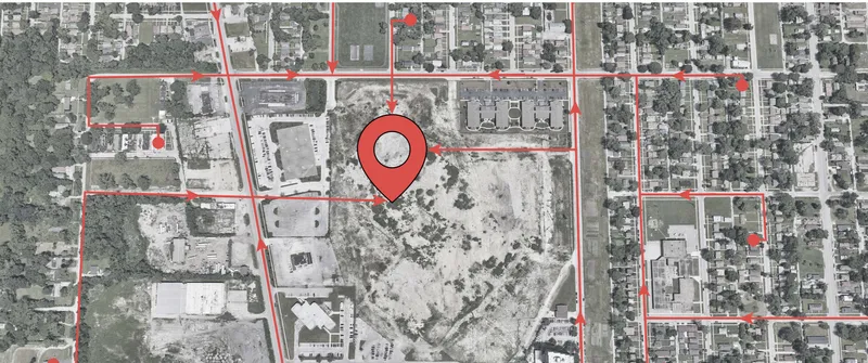 Aerial site plan with red boundary lines and location pin marking the site