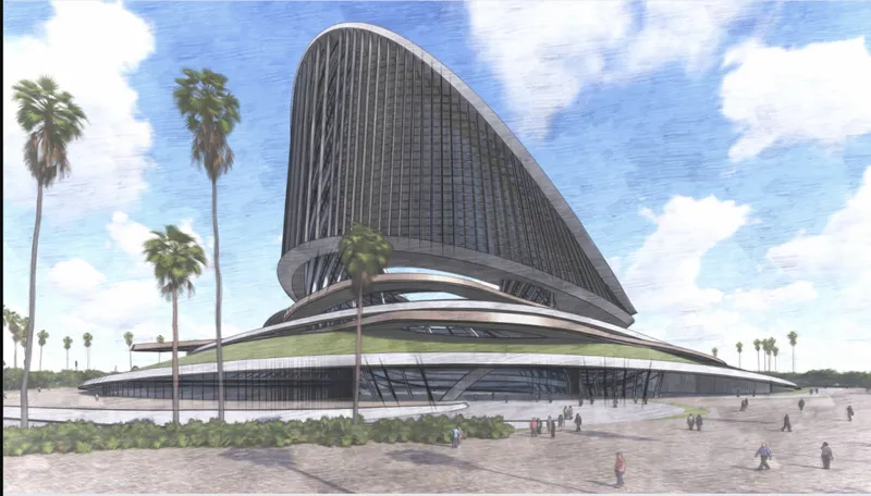 Land approach: the tower seen from a beach-side promenade with palms, pedestrians on the walkway, and the low recreational base stretching along the waterfront