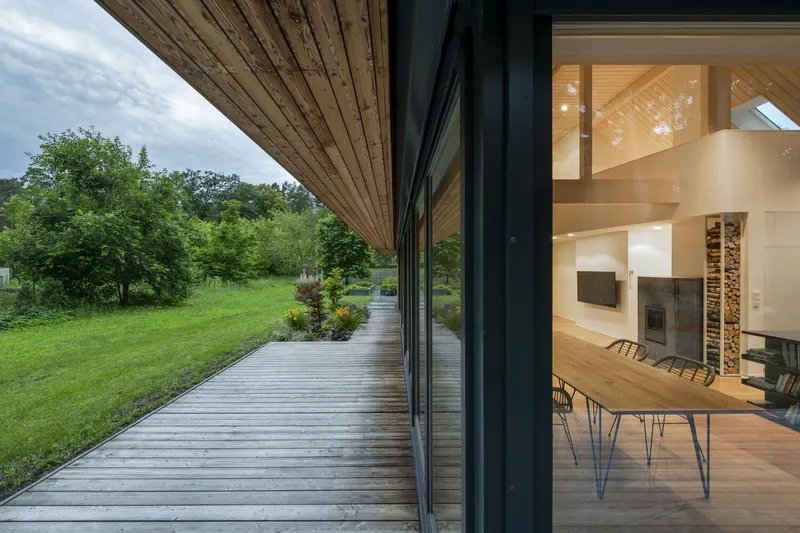 Timber deck wrapping the perimeter with views into the dining area through floor to ceiling glass