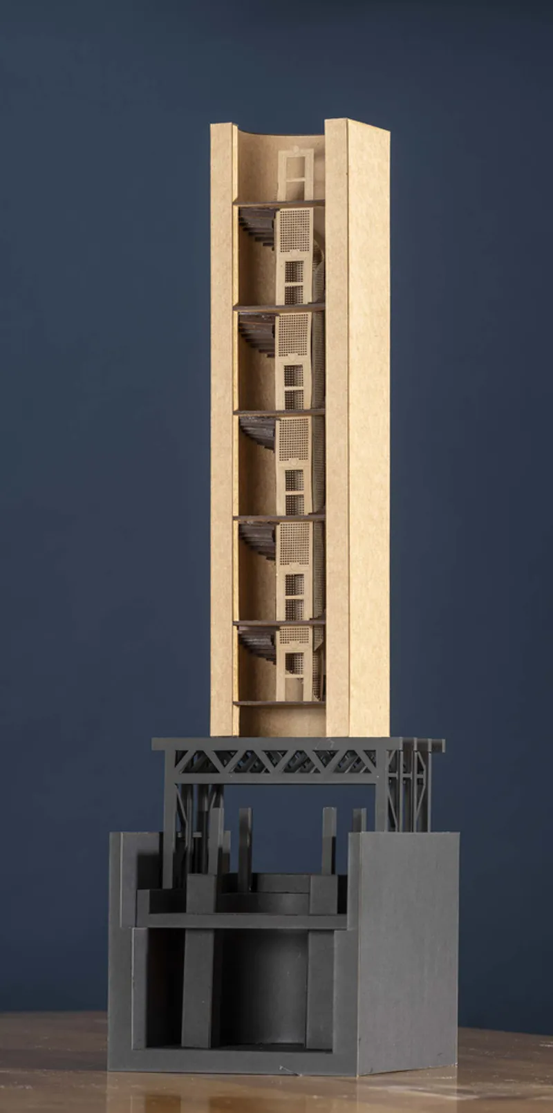 Sectional model showing the tower volume above and the structural base below with visible internal columns