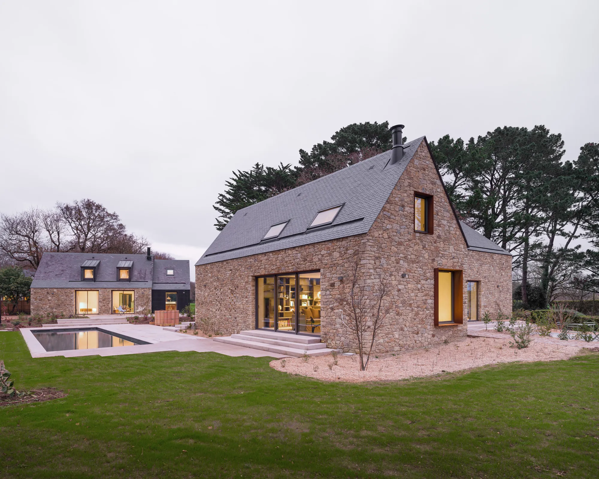 MSR Architecture Stitches a French Farmstead Back Together with Granite, Corten, and a Village Square Pool