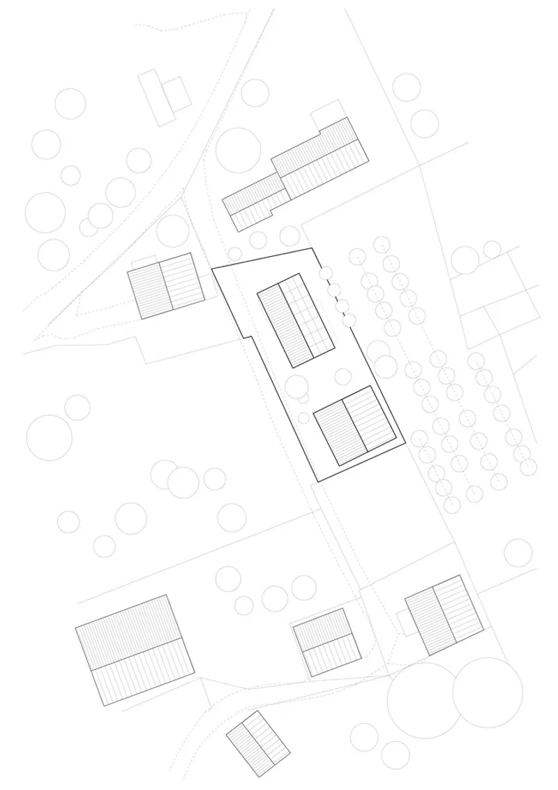 Site plan drawing showing scattered rectangular building footprints among circular tree symbols and curving roads