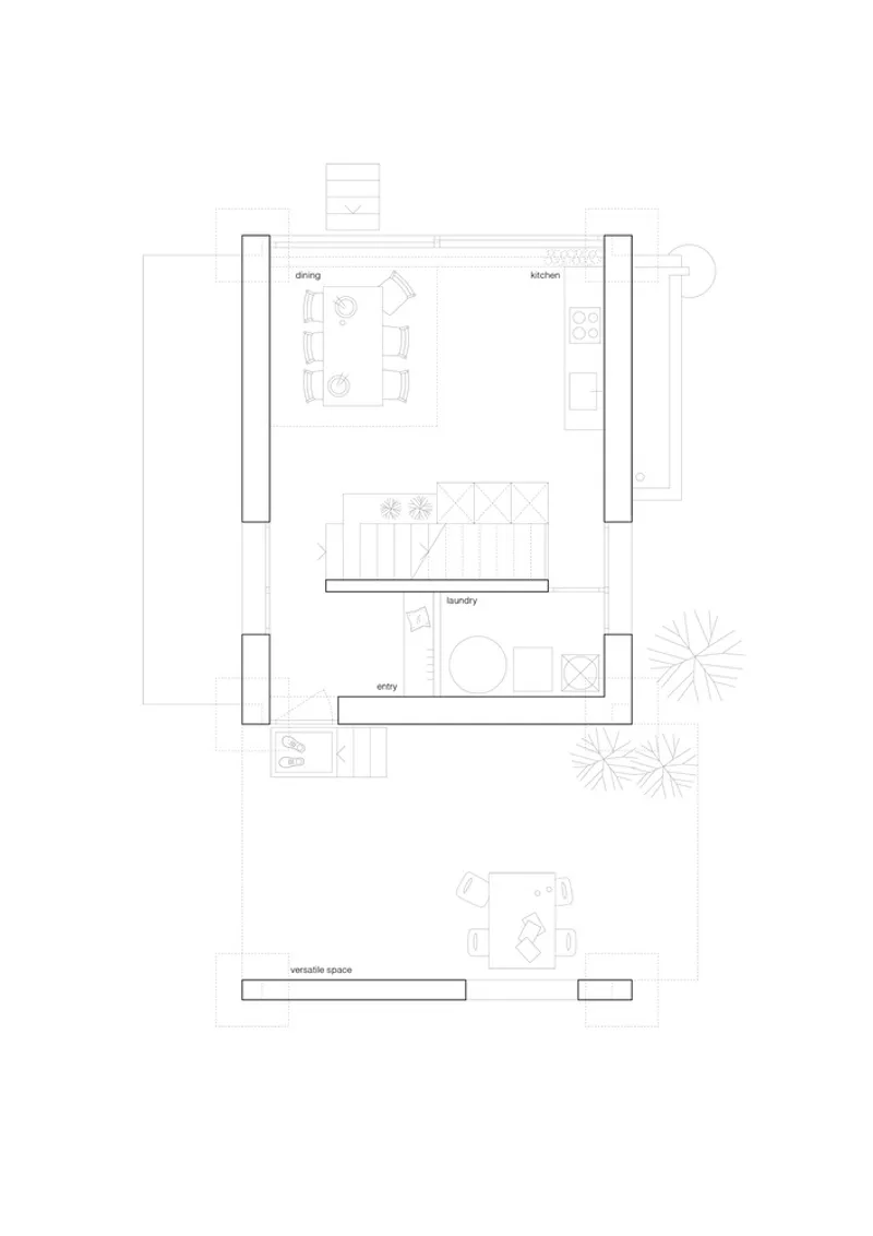 Ground floor plan drawing showing dining and kitchen spaces flanked by symmetrical vertical circulation elements