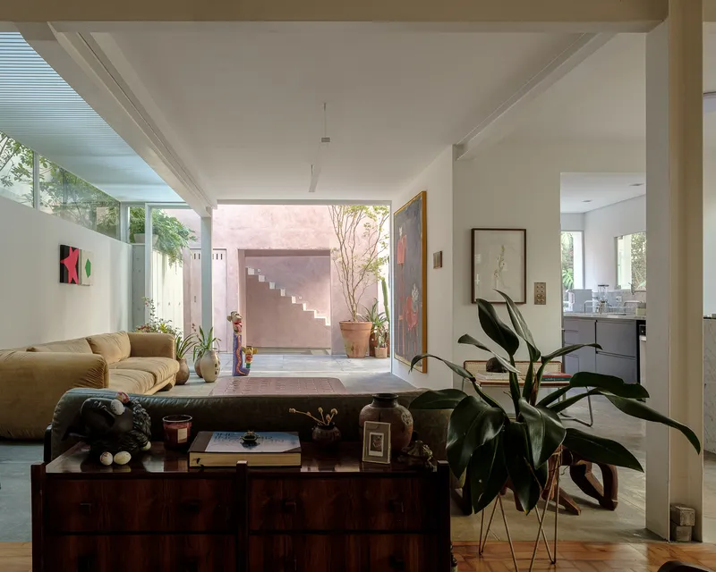 Living room looking toward the courtyard staircase framed by glazed opening and clerestory windows